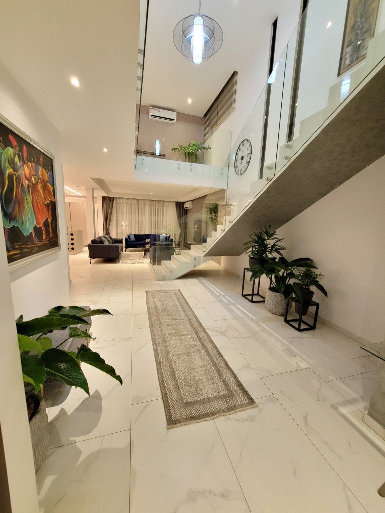 Light-filled interior with staircase and seating